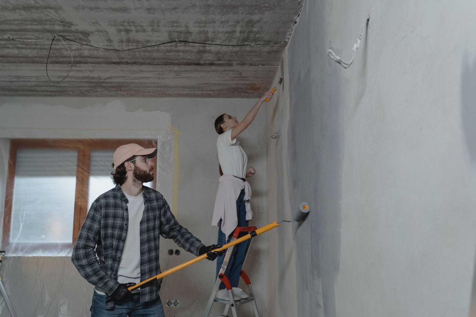 A couple painting a room together, highlighting teamwork in home renovation. — "Window Replacement in Columbia: A Smart Inves